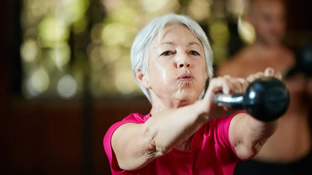 Toning Arms Without the Bulk: Is It Achievable? 1 Woman doing resistance band exercises for toned arms Chippenham